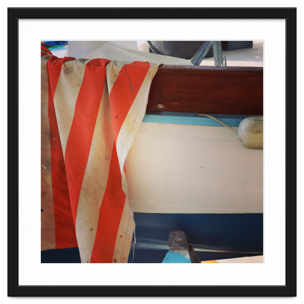 Fishing boat and striped sail