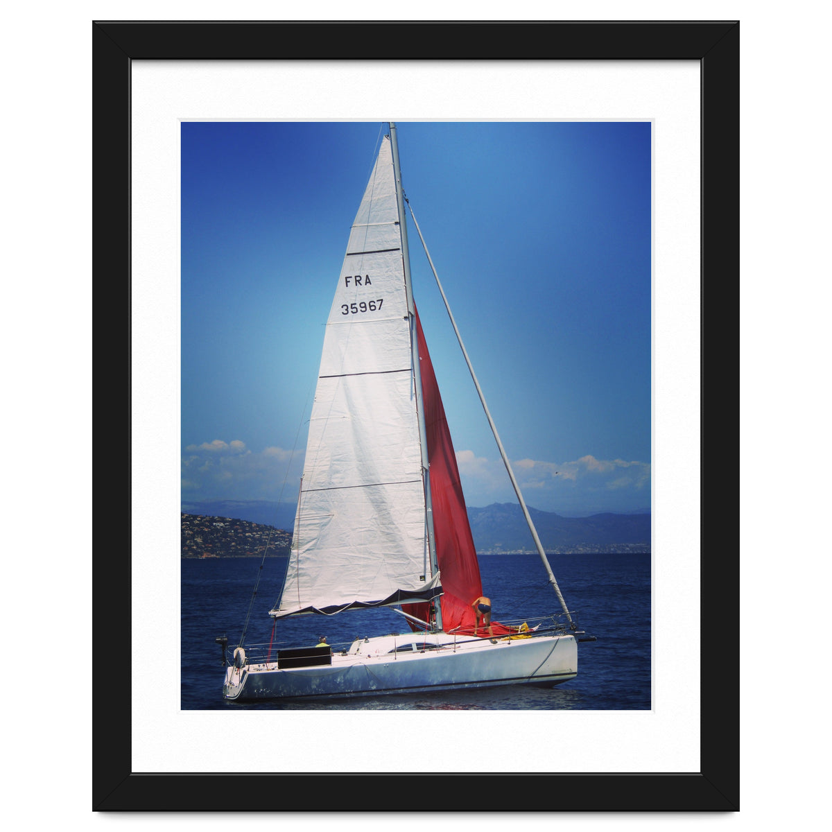 Sailing yacht with white and red sails