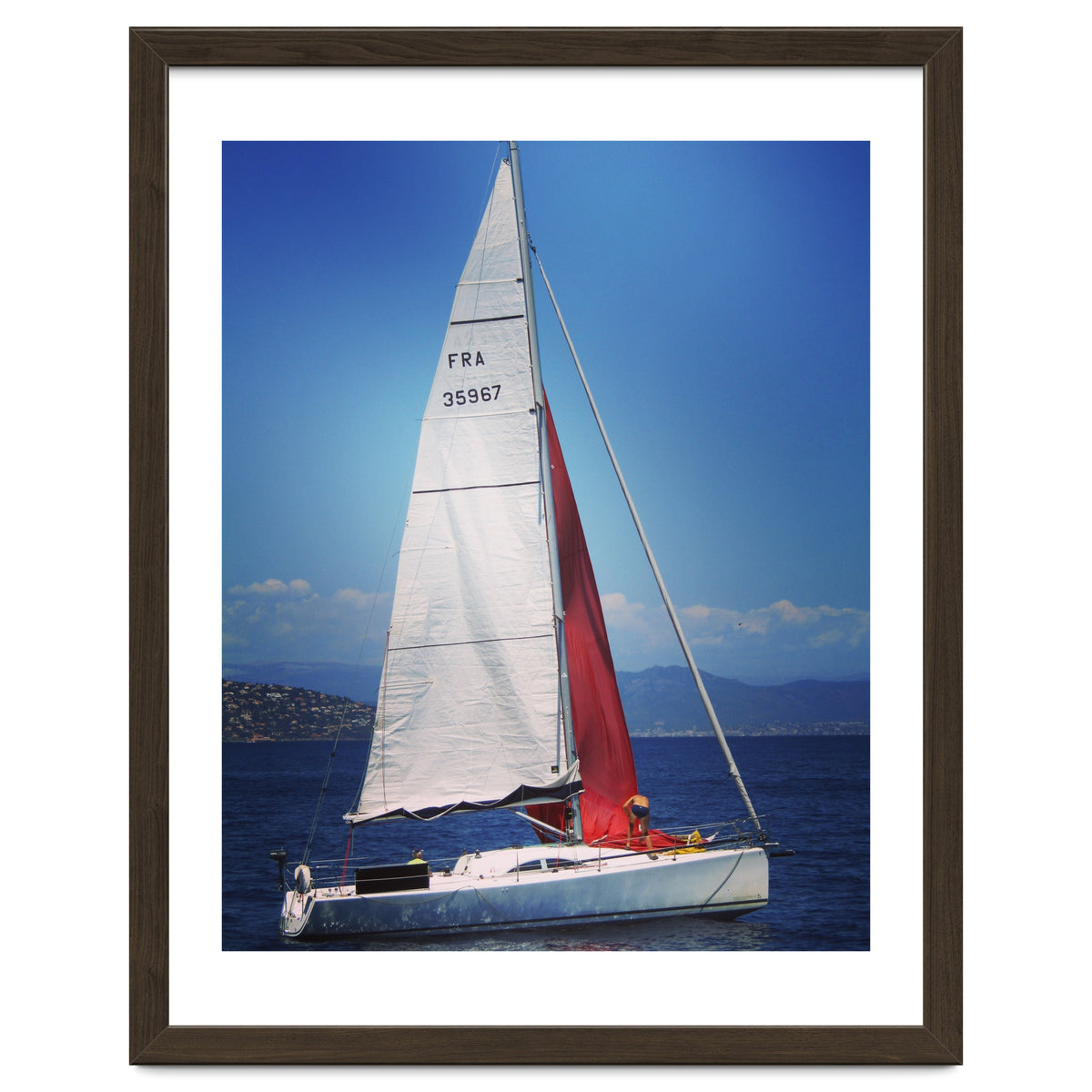 Sailing yacht with white and red sails