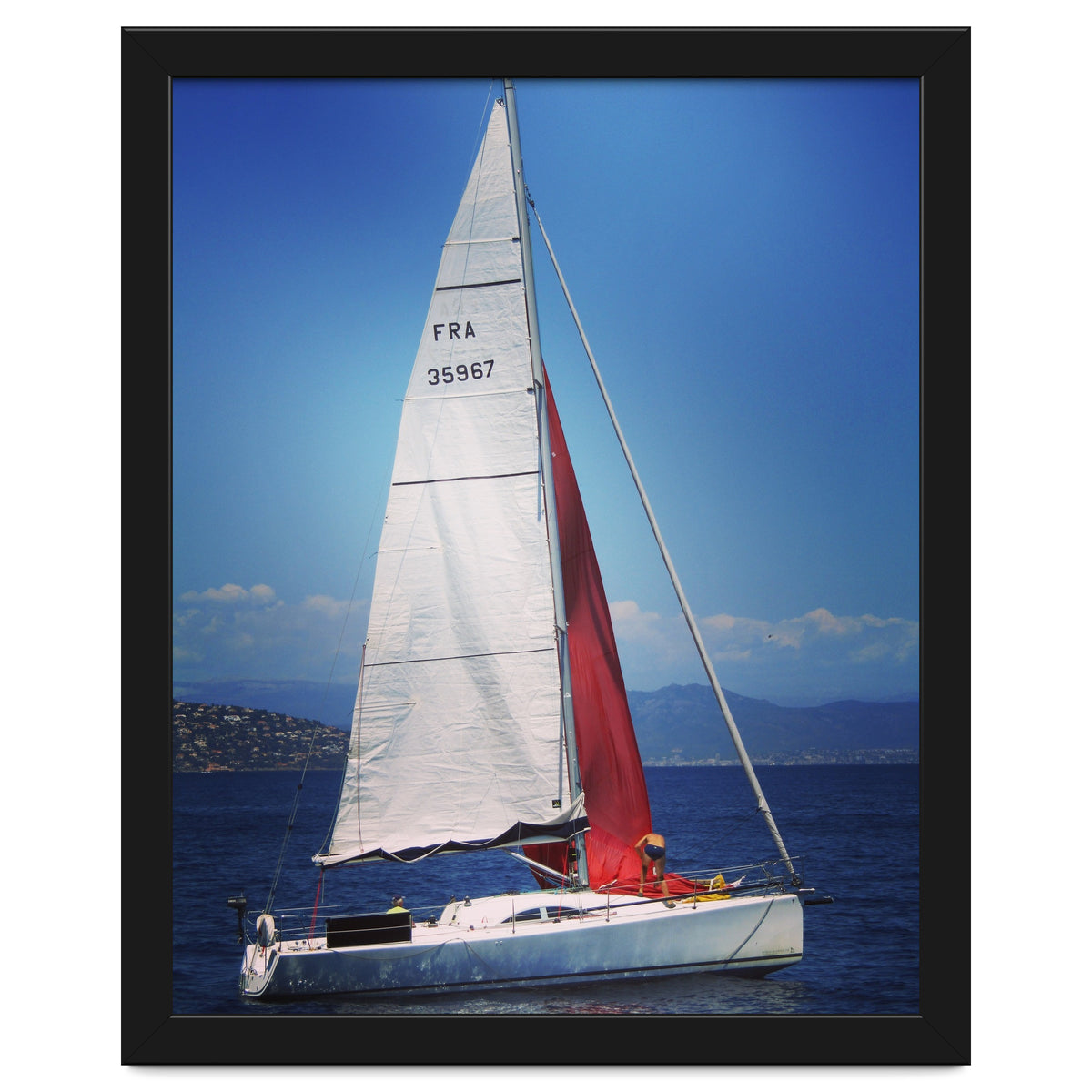 Sailing yacht with white and red sails