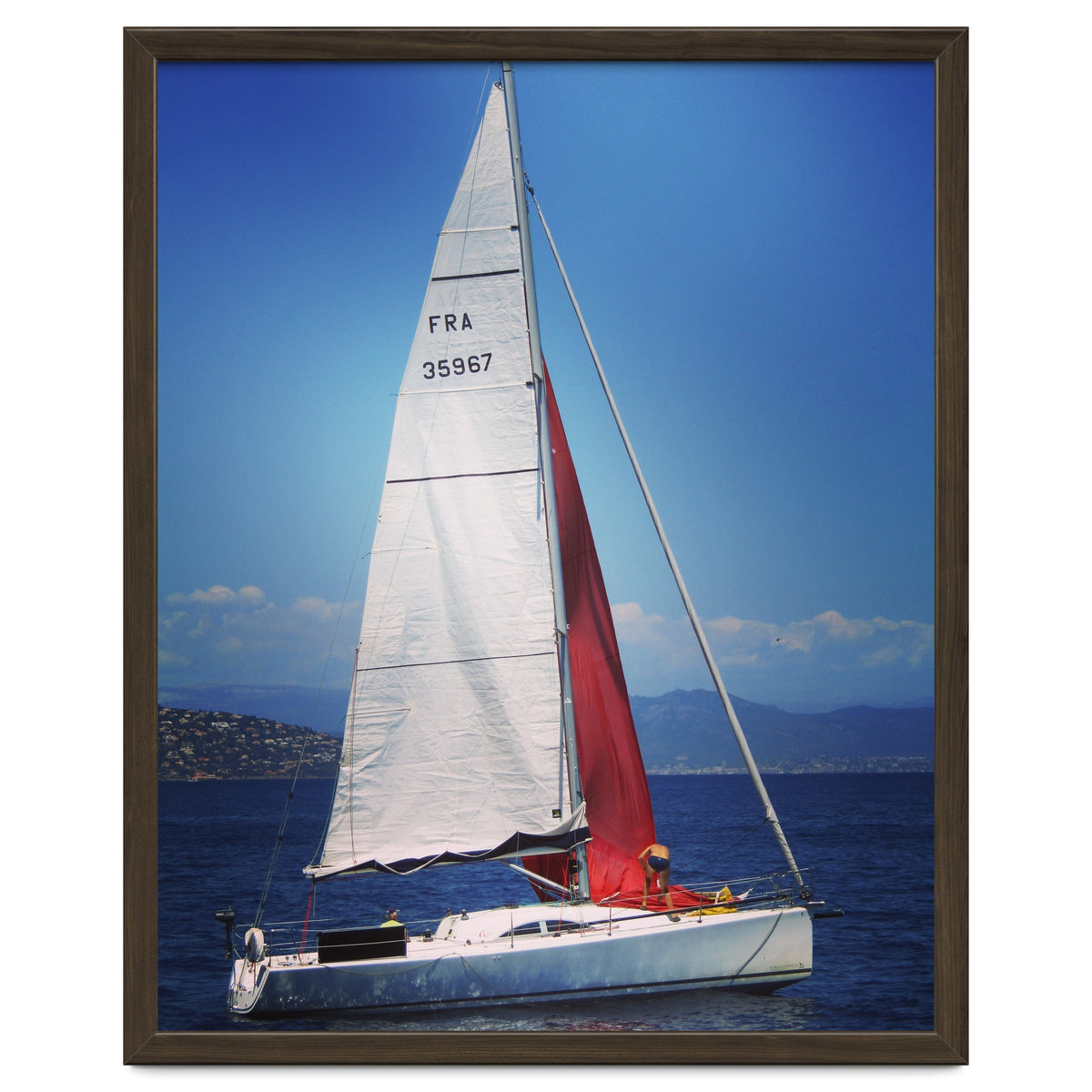 Sailing yacht with white and red sails