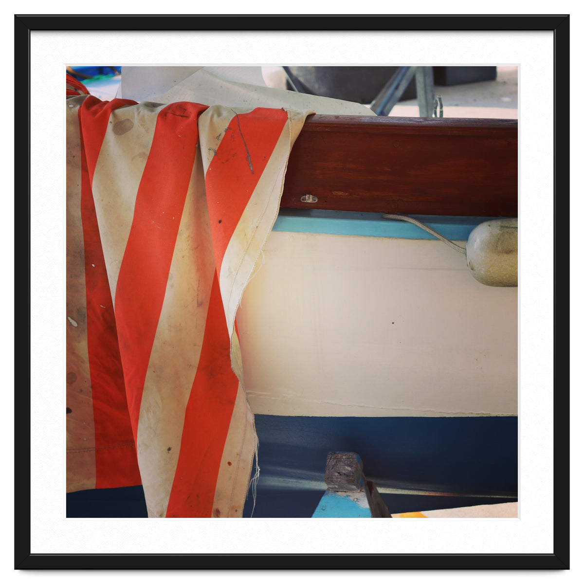 Fishing boat and striped sail