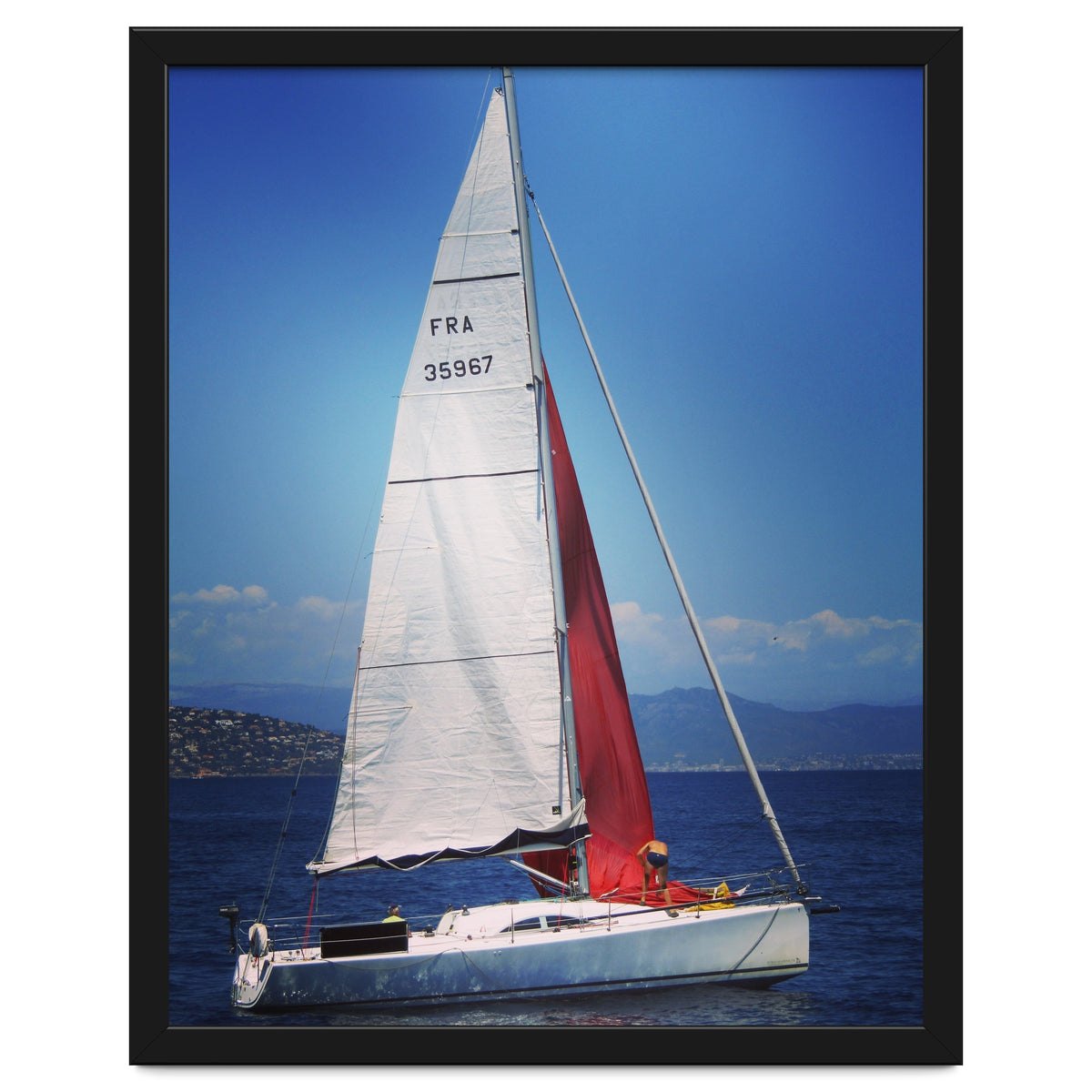 Sailing yacht with white and red sails