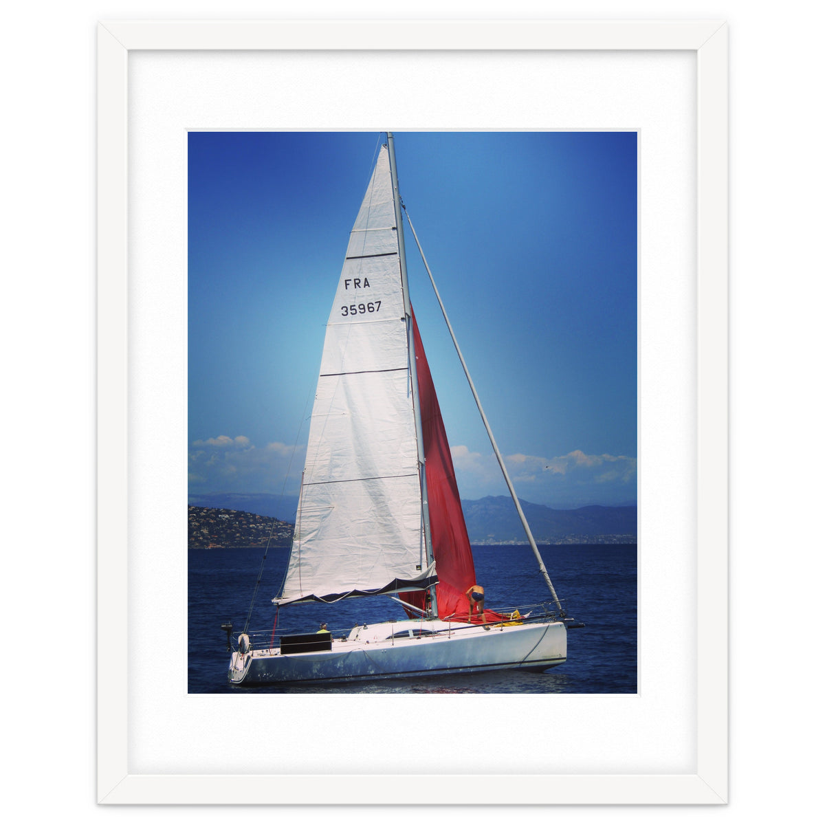 Sailing yacht with white and red sails