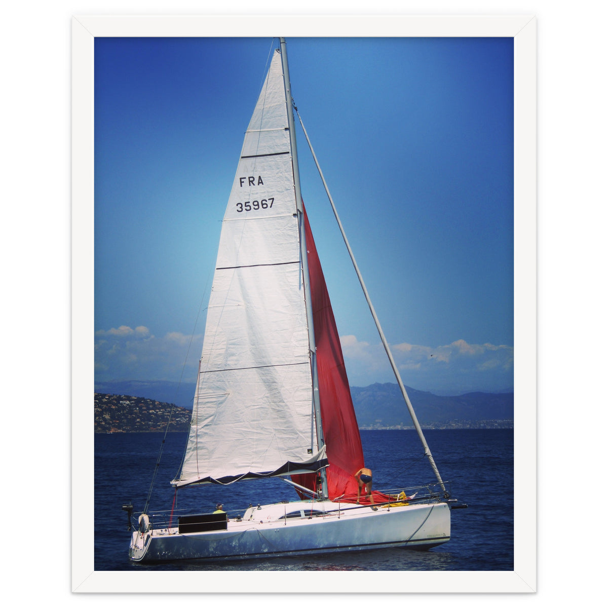 Sailing yacht with white and red sails