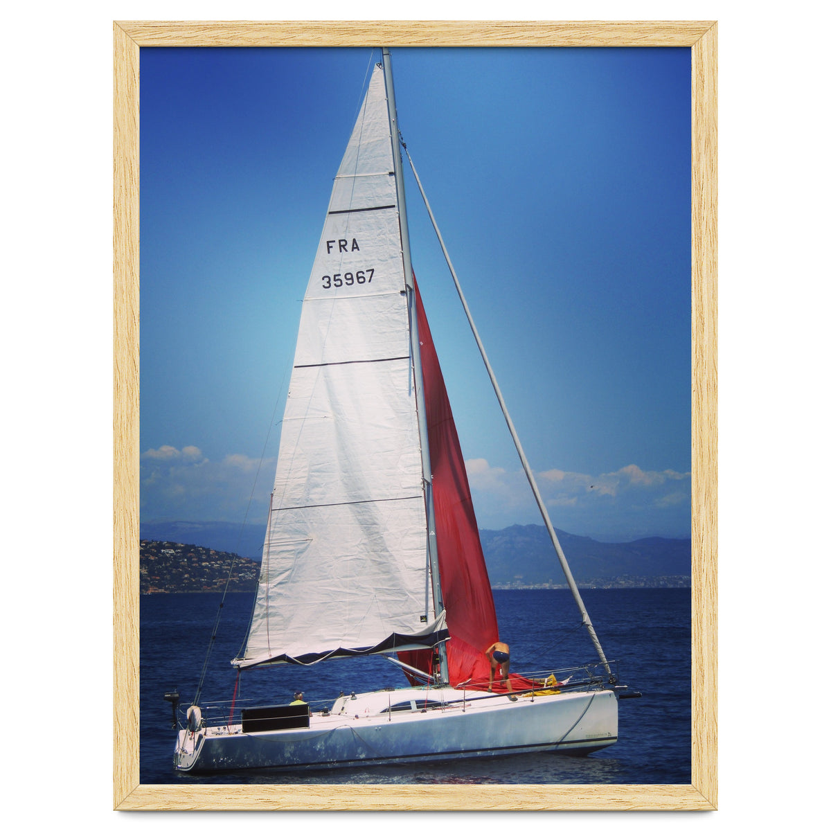 Sailing yacht with white and red sails