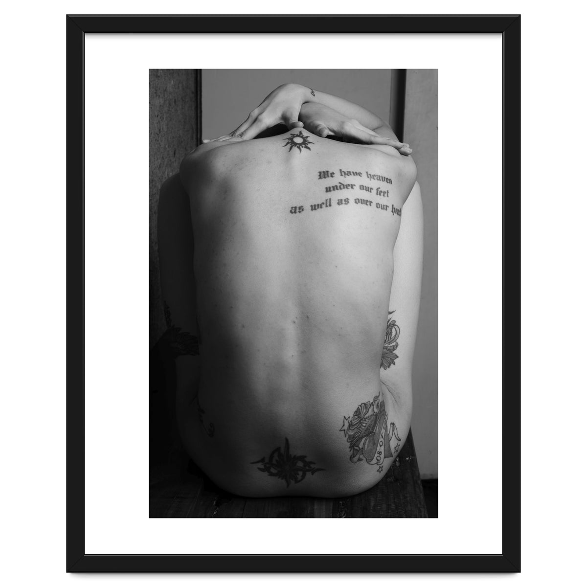 Naked body with saying as tattoo