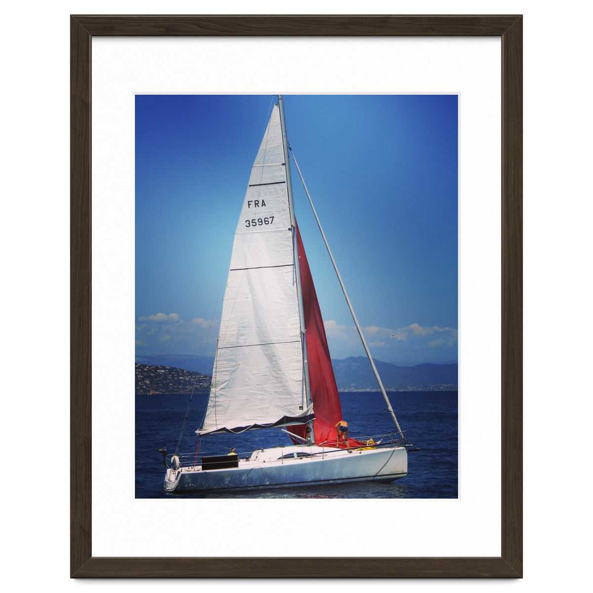 Sailing yacht with white and red sails