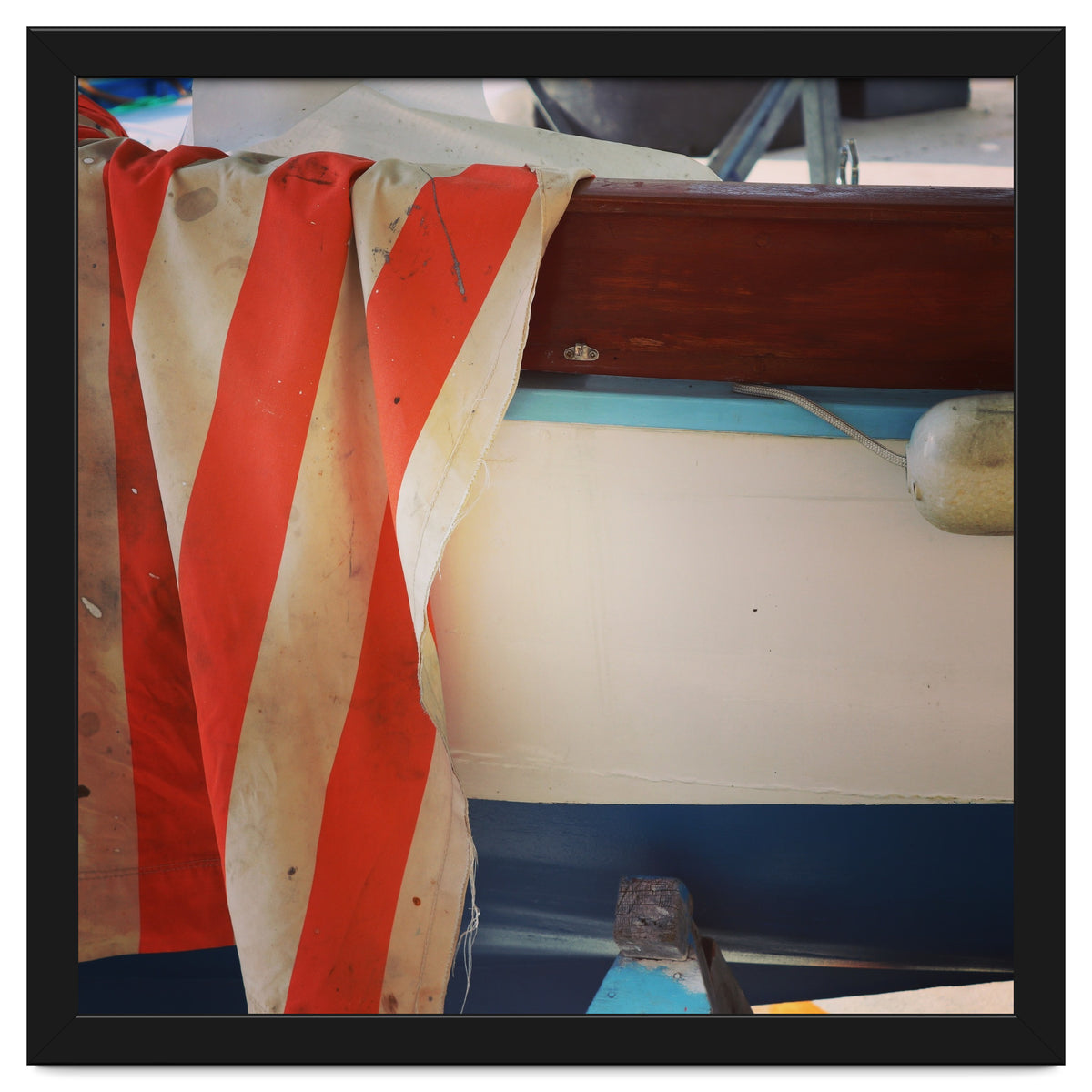 Fishing boat and striped sail